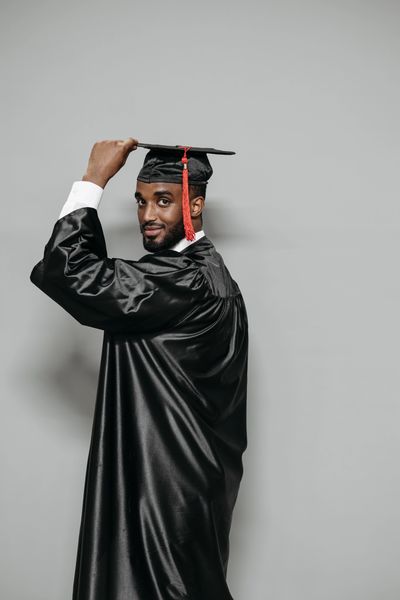 Young Black man. PA student wearing cap & gown.