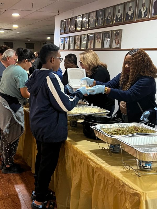 Volunteers giving out food at our Community Thanksgiving Dinner