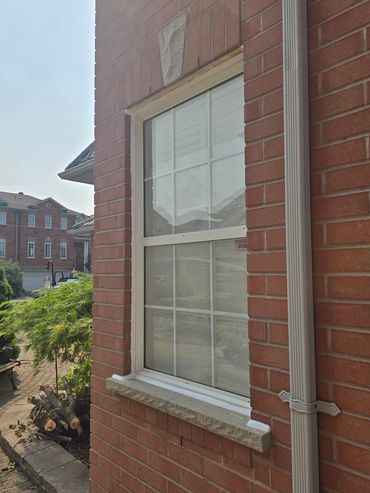 White silicone sealant applied to window in mississauga.
