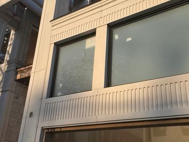 Applying sealant to the window perimeter on the precast concrete structure.