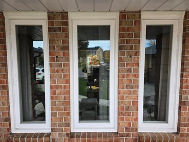 Close-up view of a smooth, new line of white caulk sealing a window for weather insulation.