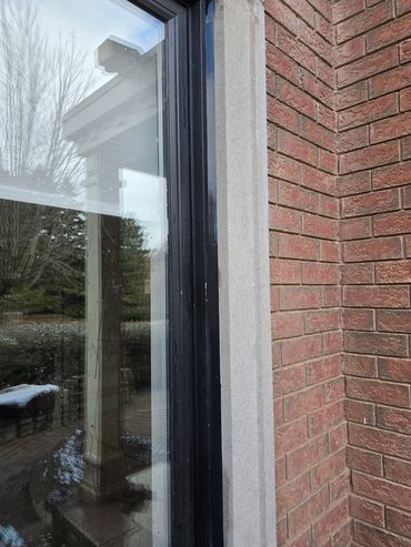 Caulking window with black silicone.