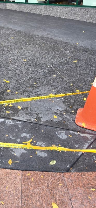 Caulking granite joints on ground.