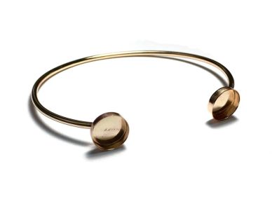 Minimalist open-ended gold bracelet with round ends.