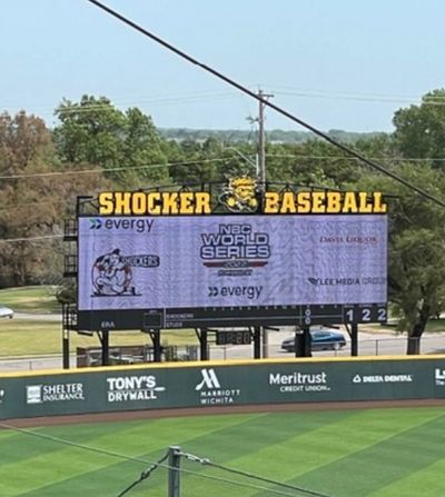 Shocker Baseball scoreboard at a stadium showing NBC World Series info.