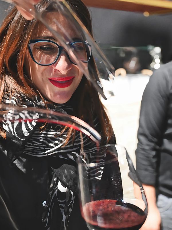 restaurant owner pouring wine
