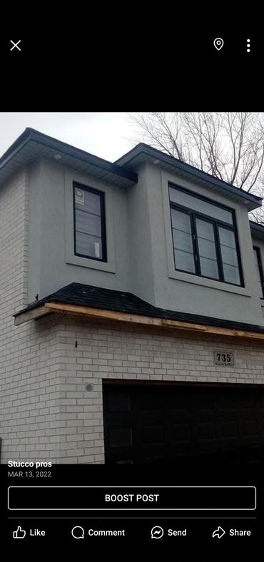 Modern two-story house with stucco and brick exterior.