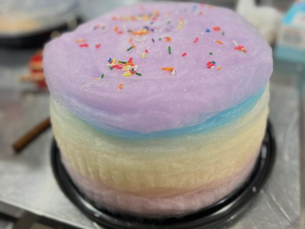 Pastel rainbow cotton candy cake with sprinkles.