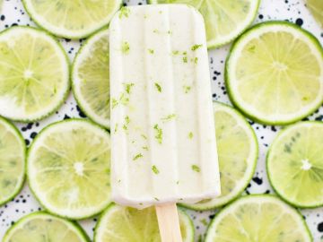 Lime popsicle on lime slice background.