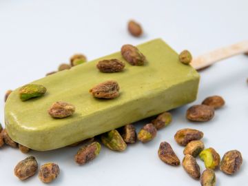 Pistachio ice cream bar with whole pistachios.