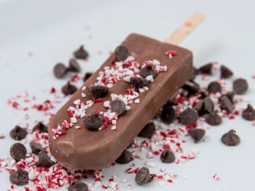 Chocolate popsicle with chocolate chips and sprinkles.