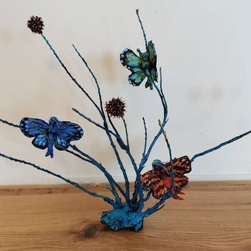 Colorful butterfly and flower metal sculpture.
