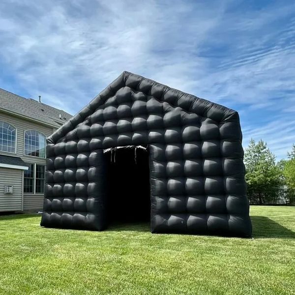 The Ultimate inflatable Nightclub structure resembling a house in a backyard.