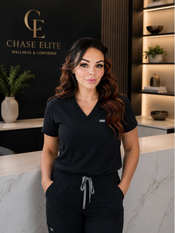 Confident woman in black scrubs at Chase Elite Wellness &amp; Concierge.