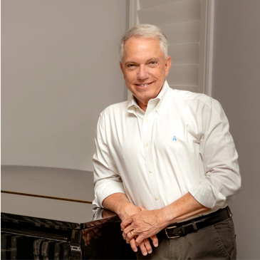 Man in white shirt leaning on table