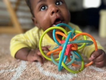 Baby playing with a colorful toy.