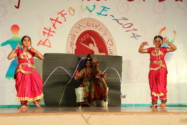 Young girls performing a traditional dance on stage.