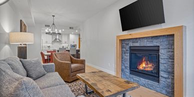 Modern living room with a cozy fireplace and stylish furniture.