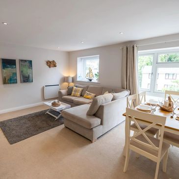 spacious and bright open plan lounge and dining area with comfortable sofa.
