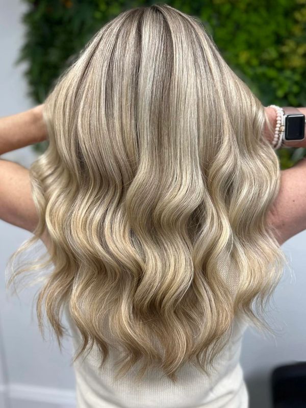 Long, wavy blonde hair with subtle highlights and a healthy shine.