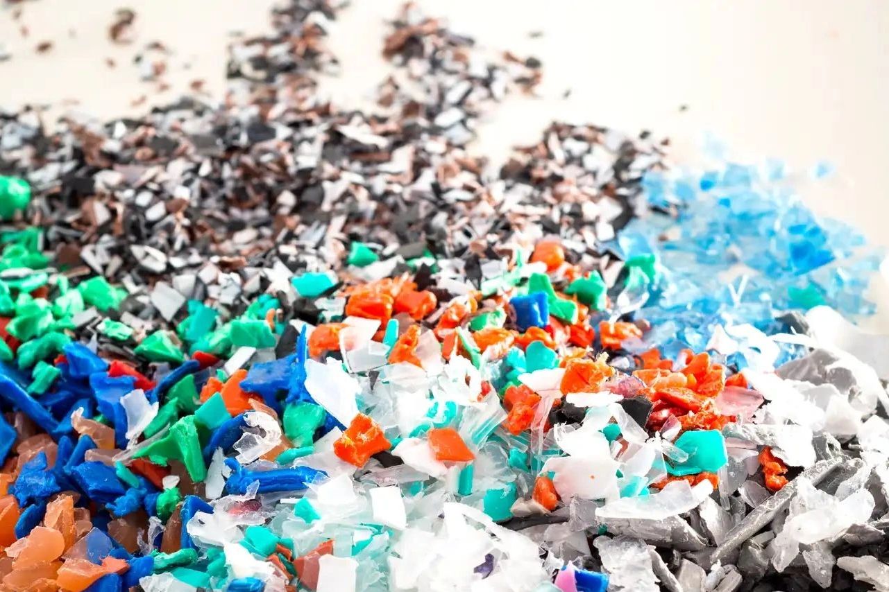 Close-up of colorful plastic flakes sorted by color.