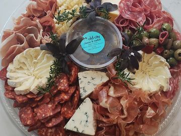 A gourmet charcuterie platter with assorted meats, cheeses, and olives.