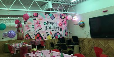 A colorful birthday party setup with decorations and party hats.