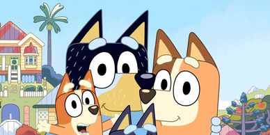 Animated dog family smiling in front of their colorful house.