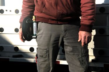 Man showing a suction cup holstered in the Cup Keeper.