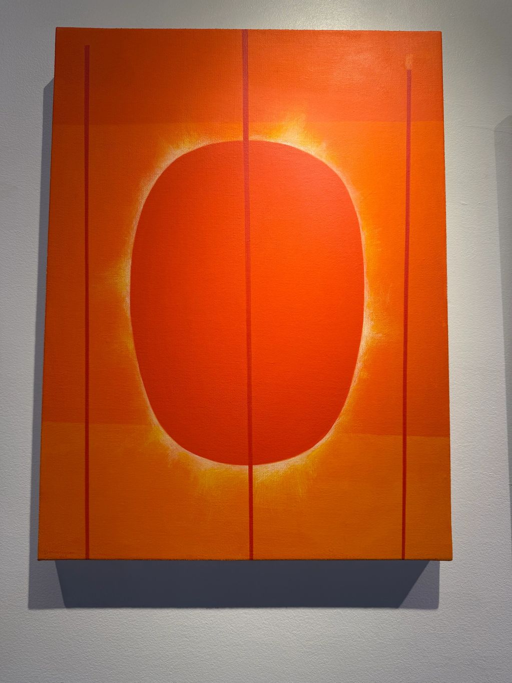 Abstract orange painting with glowing oval and vertical lines.