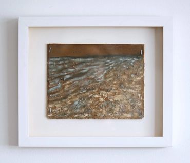 Framed textured artwork with earth tones and a wavy pattern.