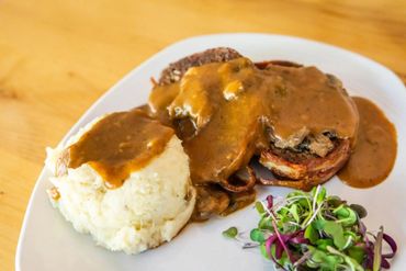 A plate of mashed potatoes and gravy