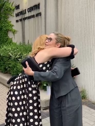 Two women embracing outside the Camille Centre.