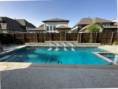 Backyard swimming pool with water fountains.