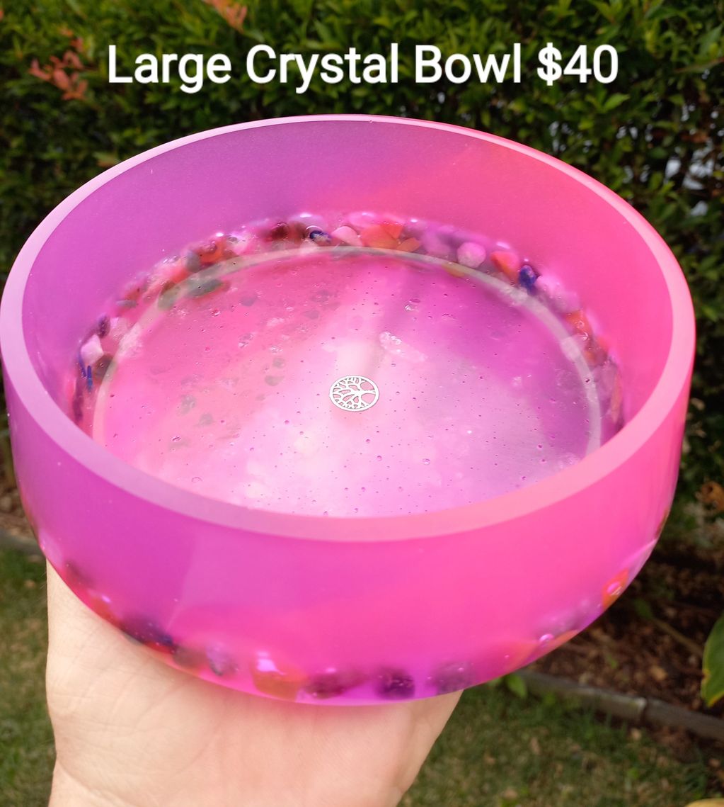 A vibrant pink crystal bowl with embedded colorful stones, priced at $40.