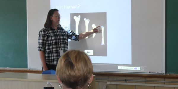 Teacher pointing at bone images during a lesson.
