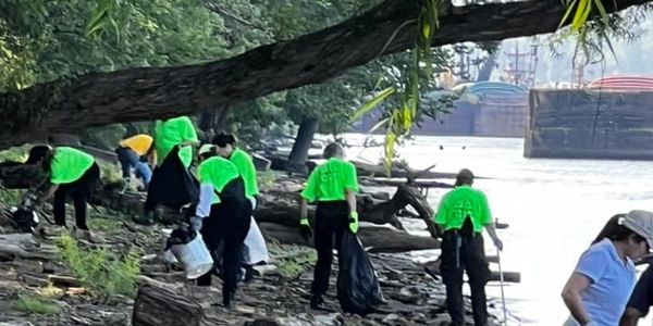 Volunteers cleaning a riverside area.