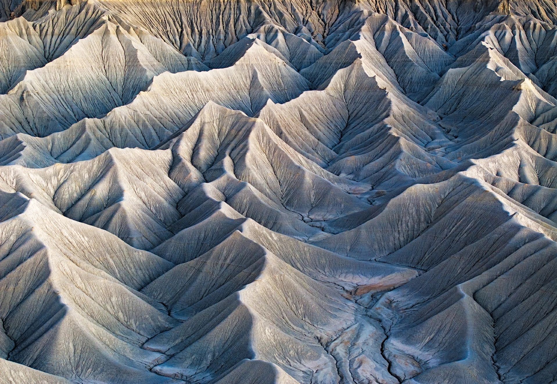 Textured, layered hills with erosion marks.