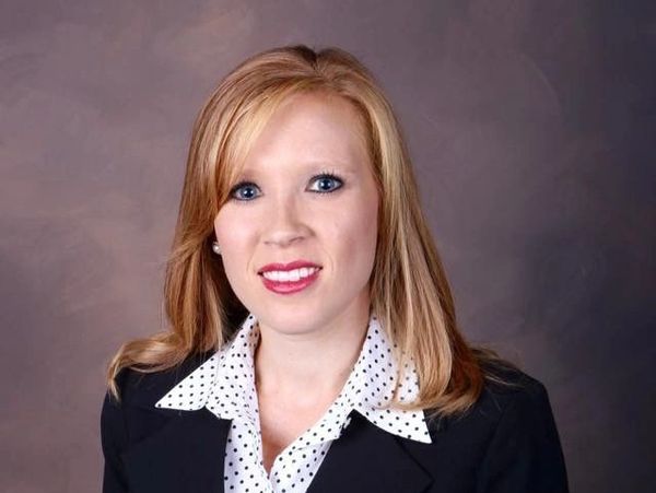 Professional portrait of a woman in business attire.
