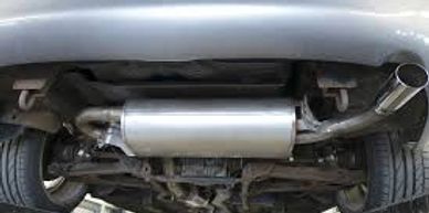 Silver car on lift showing new shiny muffler