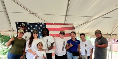 IFSH volunteers posing for the camera in front of the American flag.