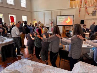 People participating in a group activity in a hall.