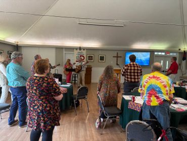 People standing in a room for a group event or service.
