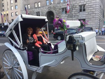 Happy customers take a ride with Troy Carriages