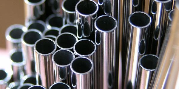 Close-up of shiny metal pipes arranged vertically.