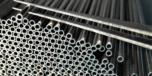 Stacked metal tubes with hollow centers, arranged closely together.