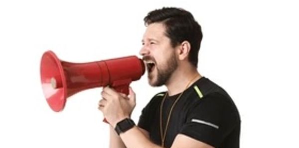 Man shouting into a red megaphone.