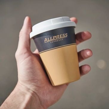Hand holding an Allpress Espresso cup.