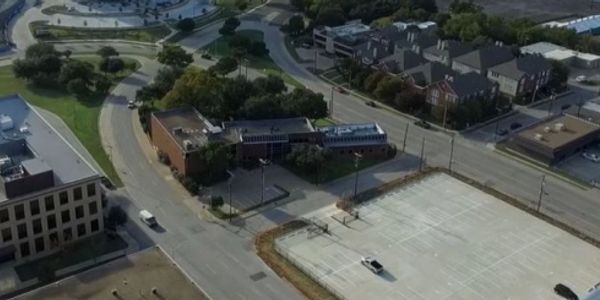 Aerial view of an urban area with roads and buildings.