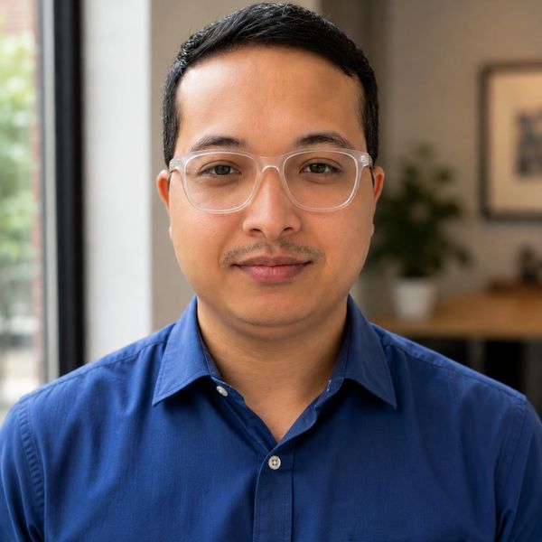 Man with glasses in a blue shirt.